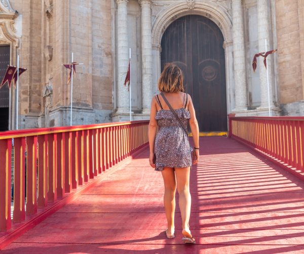 A young tourist on the red carpet of the Santa Iglesia Catedral in the city of Cadiz. Andalusia